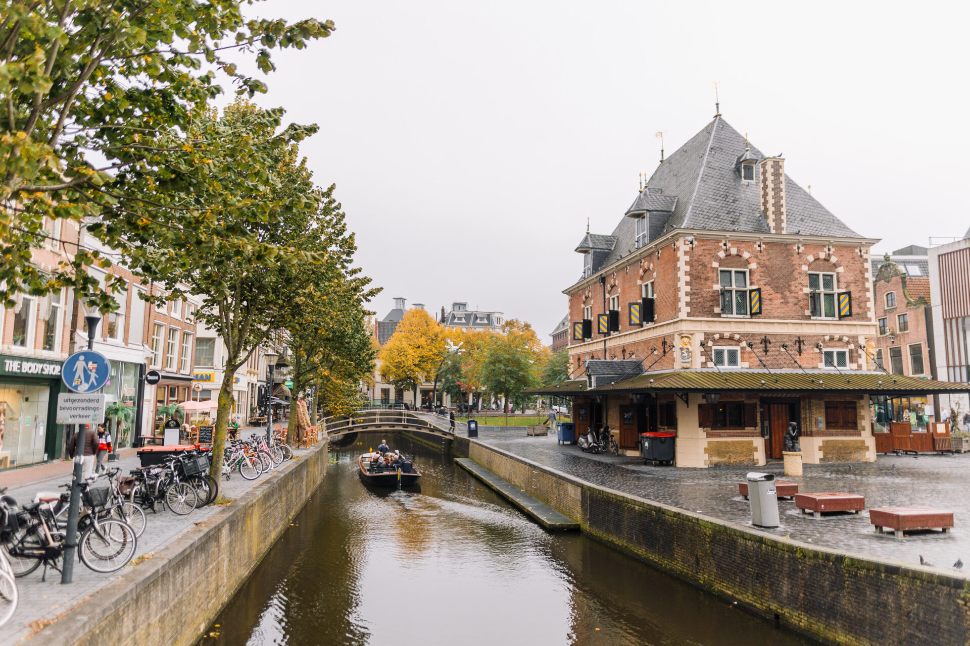 De Waag op de Nieuwestad, omringd met bomen die door de herfst verkleuren.