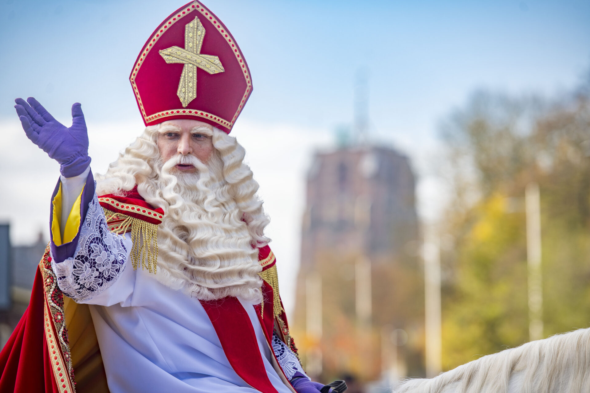 Sinterklaas zwaait op de achtergrond is vaag de Oldehove te zien.